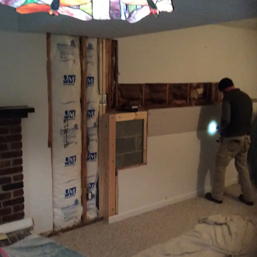 Restoration technician inspecting water damage in Melissa